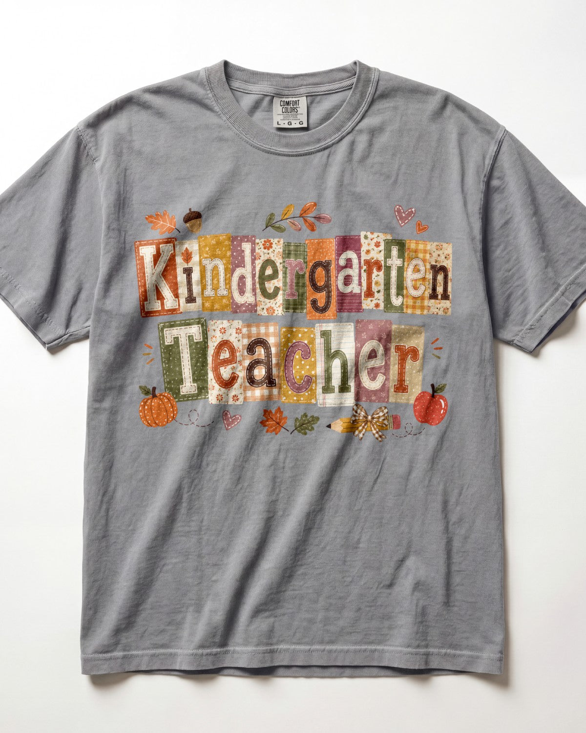 Light gray crew-neck short-sleeve T-shirt with “Kindergarten Teacher” fall graphic print