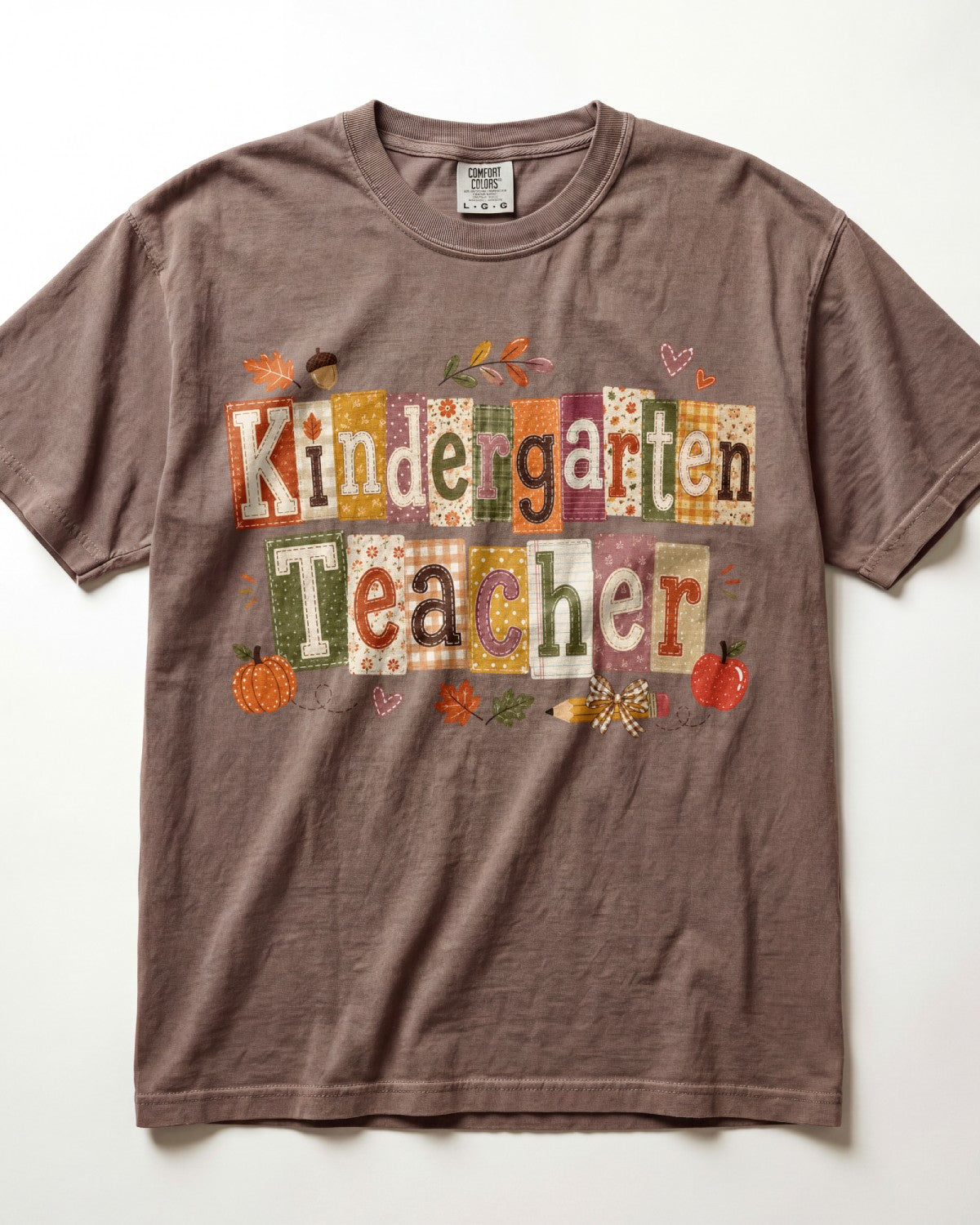 Brown crew-neck short-sleeve T-shirt with “Kindergarten Teacher” fall graphic print