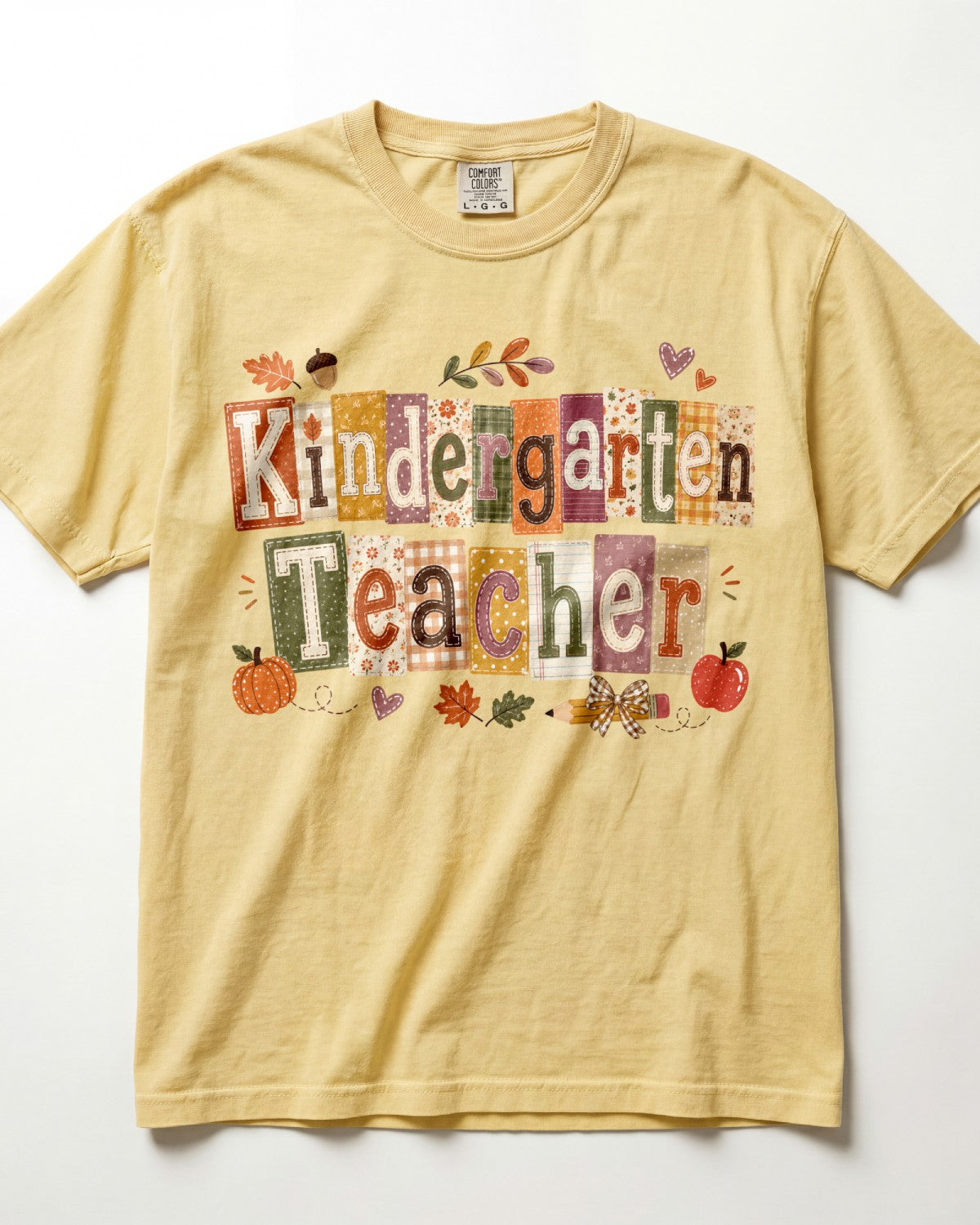 Mustard yellow crew-neck short-sleeve T-shirt with “Kindergarten Teacher” fall graphic print