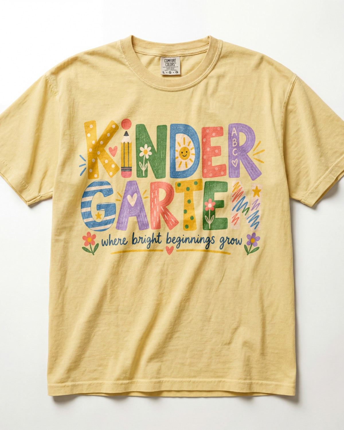 Kindergarten teacher alphabet graphic T-shirt, butter yellow with colorful print