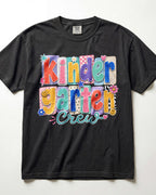 Black crewneck kids T-shirt with “Kinder Garten Crew” colorful graphic print