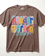 Brown crewneck kids T-shirt with “Kinder Garten Crew” colorful graphic print