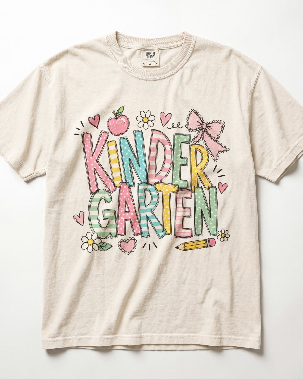 Cream kindergarten teacher T-shirt with colorful “Kinder Garden” graphic and pencils