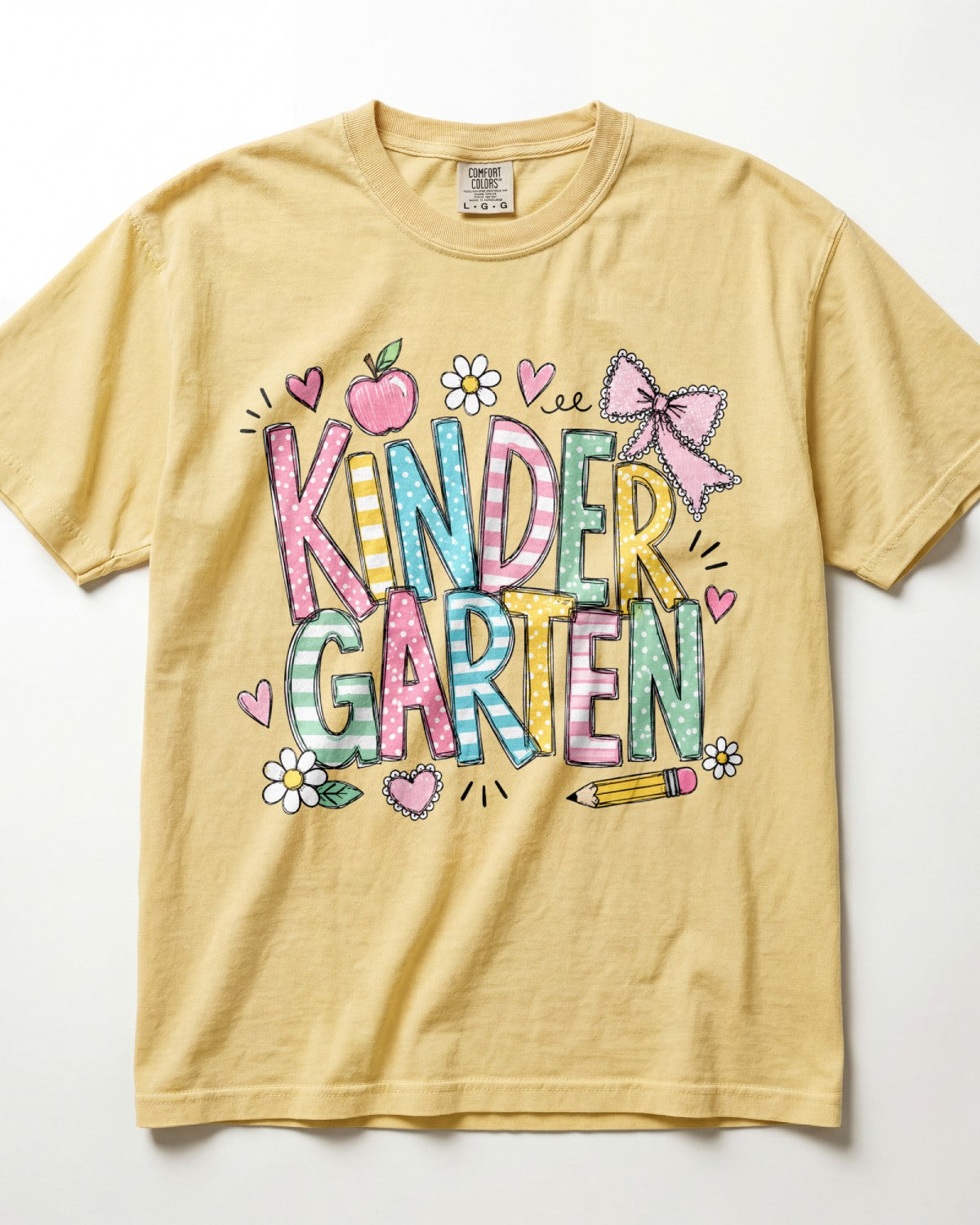 Mustard yellow kindergarten teacher T-shirt with colorful “Kinder Garden” graphic and pencils