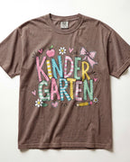 Brown kindergarten teacher T-shirt with colorful “Kinder Garden” graphic and pencils