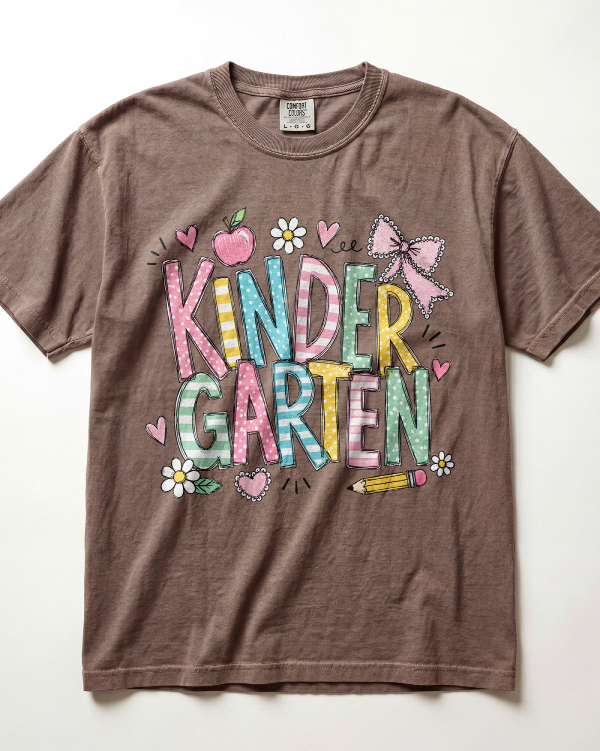 Brown kindergarten teacher T-shirt with colorful “Kinder Garden” graphic and pencils