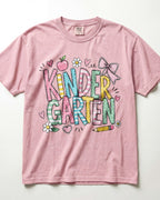 Light pink kindergarten teacher T-shirt with colorful “Kinder Garden” graphic and pencils