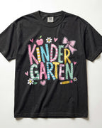 Black kindergarten teacher T-shirt with colorful “Kinder Garden” graphic and pencils