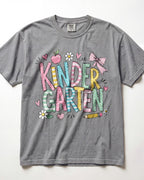 Light gray kindergarten teacher T-shirt with colorful “Kinder Garden” graphic and pencils
