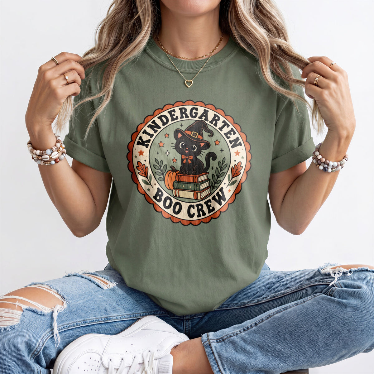 Sage green crewneck short-sleeve T-shirt with circular “Boo Crew” graphic front on model